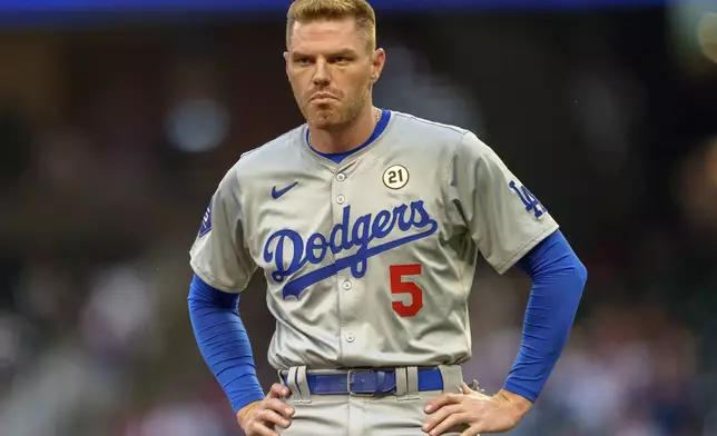 Los Angeles Dodgers' Freddie Freeman awaits a teammate to bring out his glove and hat in the first inning of a baseball game against the Atlanta Braves, Sunday, Sept. 15, 2024, in Atlanta. (AP Photo/Jason Allen)