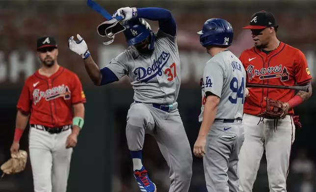 Los Angeles Dodgers' Teoscar Hernández (37) celebrates his double against the Atlanta Braves in the third inning of a baseball game, Friday, Sept. 13, 2024, in Atlanta. (AP Photo/Mike Stewart)