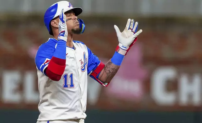 Atlanta Braves' Orlando Arcia (11) gives praise when he reaches second base after hitting a double to center field in the third inning of a baseball game against the Los Angeles Dodgers, Saturday, Sept. 14, 2024, in Atlanta. (AP Photo/Jason Allen)