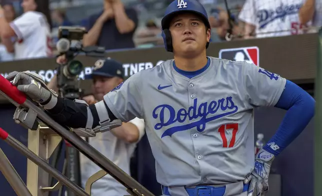 Los Angeles Dodgers' Shohei Ohtani watches the scoreboard before his turn at bat in the first inning of a baseball game against the Atlanta Braves, Monday, Sept. 16, 2024, in Atlanta. (AP Photo/Jason Allen)