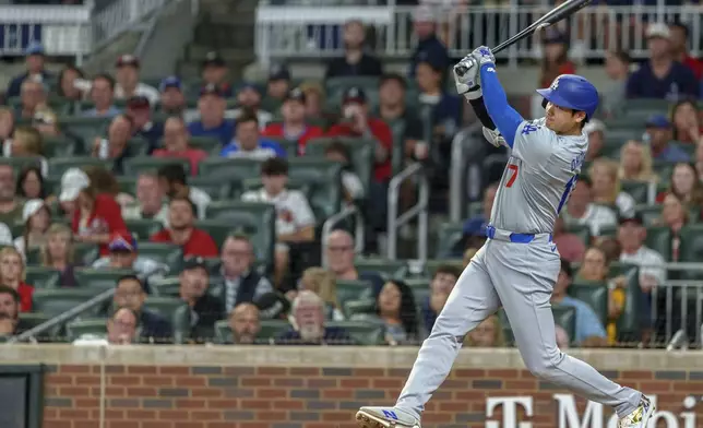 Los Angeles Dodgers' Shohei Ohtani hits a double to right field in the fifth inning of a baseball game against the Atlanta Braves, Sunday, Sept. 15, 2024, in Atlanta. (AP Photo/Jason Allen)