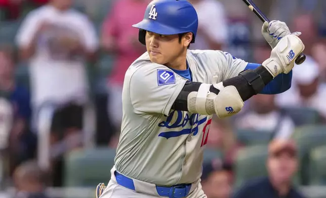 Los Angeles Dodgers' Shohei Ohtani watches the pitch in the first inning of a baseball game against the Atlanta Braves, Saturday, Sept. 14, 2024, in Atlanta. (AP Photo/Jason Allen)