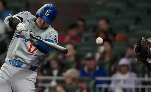 Los Angeles Dodgers' Shohei Ohtani (17) strikes out in the eighth inning of a baseball game against the Atlanta Braves, Friday, Sept. 13, 2024, in Atlanta. (AP Photo/Mike Stewart)