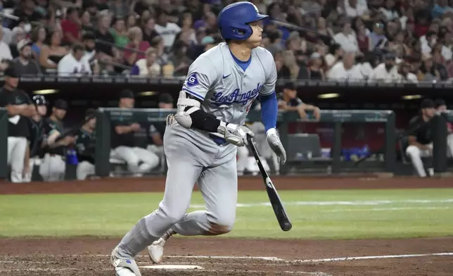 Los Angeles Dodgers' Shohei Ohtani hits a single against the Arizona Diamondbacks in the seventh inning during a baseball game, Monday, Sept. 2, 2024, in Phoenix. (AP Photo/Rick Scuteri)