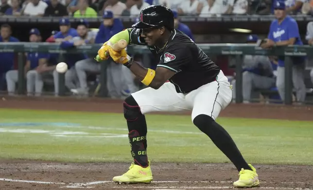 Arizona Diamondbacks' Geraldo Perdomo hits a sacrifice bunt against the Los Angeles Dodgers in the third inning during a baseball game, Monday, Sept. 2, 2024, in Phoenix. (AP Photo/Rick Scuteri)