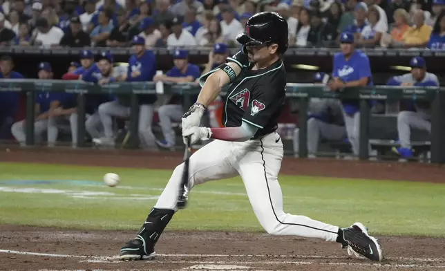 Arizona Diamondbacks' Corbin Carroll hits an RBI groundout against the Los Angeles Dodgers in the third inning during a baseball game, Monday, Sept. 2, 2024, in Phoenix. (AP Photo/Rick Scuteri)