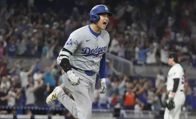 Los Angeles Dodgers' Shohei Ohtani (17) reacts after hitting his 50th home run of the season during the seventh inning of a baseball game against the Miami Marlins, Thursday, Sept. 19, 2024, in Miami. (AP Photo/Marta Lavandier)