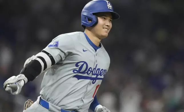 Los Angeles Dodgers' Shohei Ohtani (17) gestures after hitting a home run during the sixth inning of a baseball game against the Miami Marlins, Thursday, Sept. 19, 2024, in Miami. (AP Photo/Marta Lavandier)