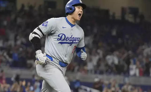 Los Angeles Dodgers' Shohei Ohtani (17) reacts after hitting his 50th home run of the season during the seventh inning of a baseball game against the Miami Marlins, Thursday, Sept. 19, 2024, in Miami. (AP Photo/Marta Lavandier)