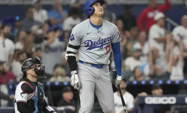 Los Angeles Dodgers' Shohei Ohtani (17) looks up after hitting a home run during the sixth inning of a baseball game against the Miami Marlins, Thursday, Sept. 19, 2024, in Miami. (AP Photo/Marta Lavandier)