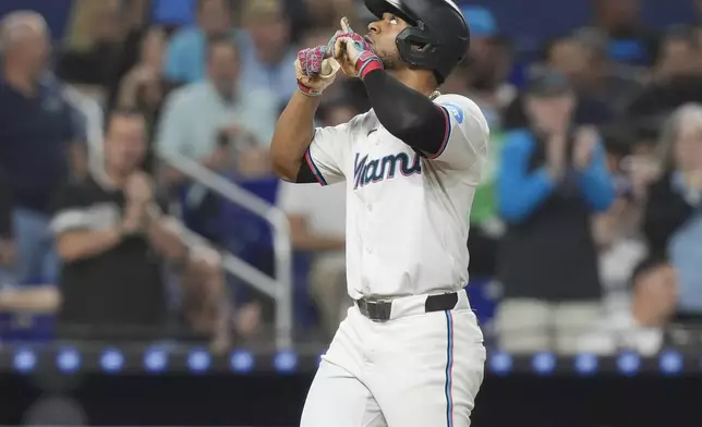 Miami Marlins' Otto Lopez gestures after hitting a home run during the third inning of a baseball game against the Los Angeles Dodgers, Tuesday, Sept. 17, 2024, in Miami. (AP Photo/Marta Lavandier)