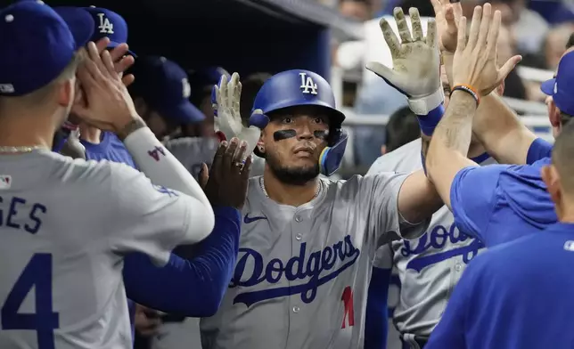 Los Angeles Dodgers' Miguel Rojas (11) celebrates after hitting a home run during the fourth inning of a baseball game against the Miami Marlins, Tuesday, Sept. 17, 2024, in Miami. (AP Photo/Marta Lavandier)