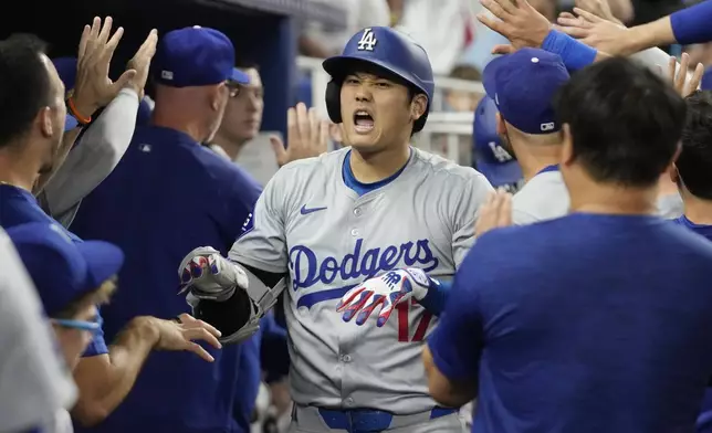 Los Angeles Dodgers' Shohei Ohtani (17) celebrates after hitting a two-run home run during the third inning of a baseball game against the Miami Marlins, Tuesday, Sept. 17, 2024, in Miami. (AP Photo/Marta Lavandier)