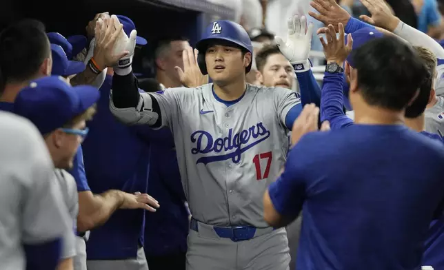 Los Angeles Dodgers' Shohei Ohtani (17) celebrates after hitting a two-run home run during the third inning of a baseball game against the Miami Marlins, Tuesday, Sept. 17, 2024, in Miami. (AP Photo/Marta Lavandier)