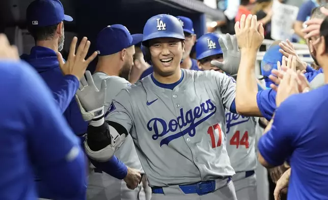 Los Angeles Dodgers' Shohei Ohtani (17) celebrates after hitting a home run during the sixth inning of a baseball game against the Miami Marlins, Thursday, Sept. 19, 2024, in Miami. (AP Photo/Marta Lavandier)