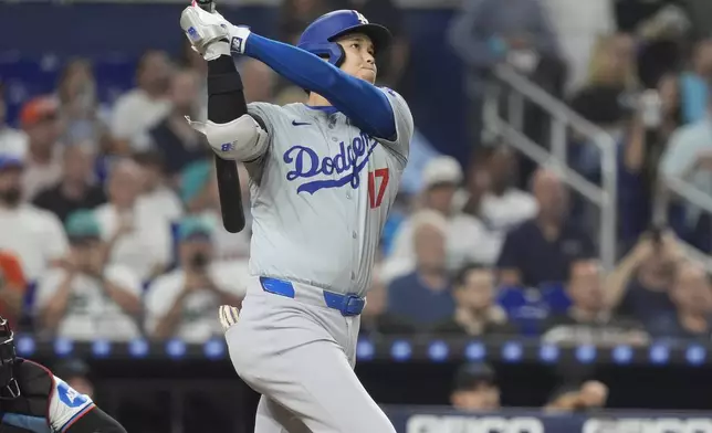 Los Angeles Dodgers' Shohei Ohtani (17) hits a two-run home run during the third inning of a baseball game against the Miami Marlins, Tuesday, Sept. 17, 2024, in Miami. (AP Photo/Marta Lavandier)