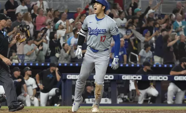 Los Angeles Dodgers' Shohei Ohtani (17) reacts after hitting his 50th home run of the season during the seventh inning of a baseball game against the Miami Marlins, Thursday, Sept. 19, 2024, in Miami. (AP Photo/Marta Lavandier)