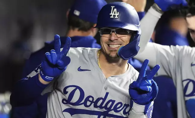 Los Angeles Dodgers' Kike Hernández (8) flashes a smiles after hitting a three-run home run during the fourth inning of a baseball game against the Miami Marlins, Wednesday, Sept. 18, 2024, in Miami. (AP Photo/Marta Lavandier)