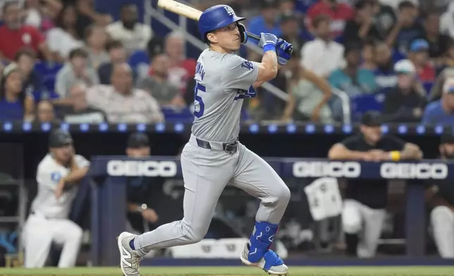 Los Angeles Dodgers' Tommy Edman (25) hits a two-run home run during the fourth inning of a baseball game against the Miami Marlins, Wednesday, Sept. 18, 2024, in Miami. (AP Photo/Marta Lavandier)