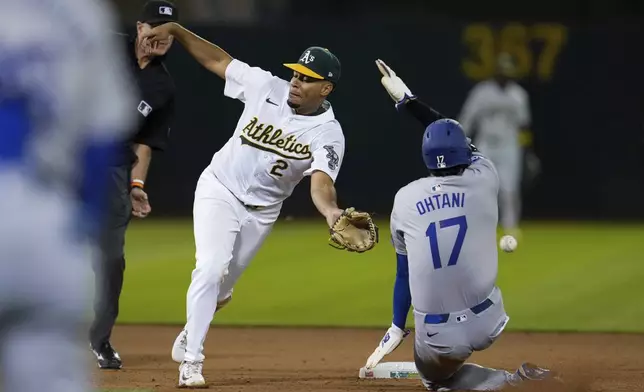 Oakland Athletics second baseman Darell Hernaiz (2) is unable to catch the throw from catcher Shea Langeliers as Los Angeles Dodgers' Shohei Ohtani steals second during the ninth inning of a baseball game, Saturday, Aug. 3, 2024, in Oakland, Calif. (AP Photo/Godofredo A. Vásquez)