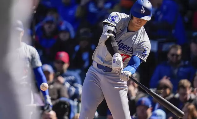 Los Angeles Dodgers' Shohei Ohtani hits a home run during the fifth inning of a baseball game against the Chicago Cubs, Friday, April 5, 2024, in Chicago. (AP Photo/Erin Hooley)