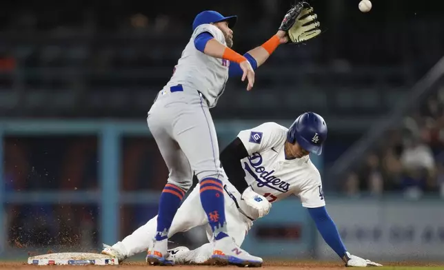 Los Angeles Dodgers designated hitter Shohei Ohtani (17) steals second ahead of a throw to New York Mets second baseman Jeff McNeil during the fourth inning of a baseball game in Los Angeles, Friday, April 19, 2024. (AP Photo/Ashley Landis)