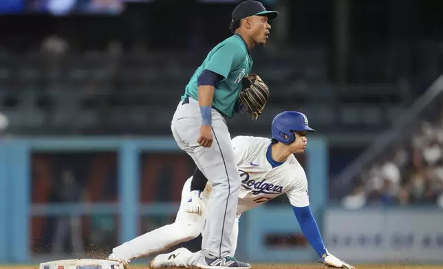 Los Angeles Dodgers designated hitter Shohei Ohtani (17) steals second base during the fifth inning of a baseball game against the Seattle Mariners in Los Angeles, Wednesday, Aug. 21, 2024. (AP Photo/Ashley Landis)