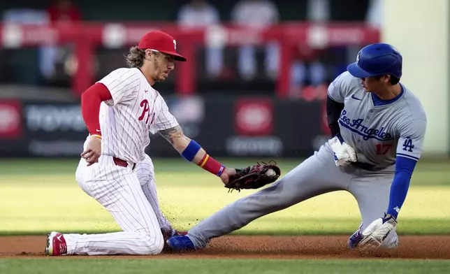 Los Angeles Dodgers' Shohei Ohtani, right, steals second past Philadelphia Phillies second baseman Bryson Stott during the first inning of a baseball game, Wednesday, July 10, 2024, in Philadelphia. (AP Photo/Matt Slocum)