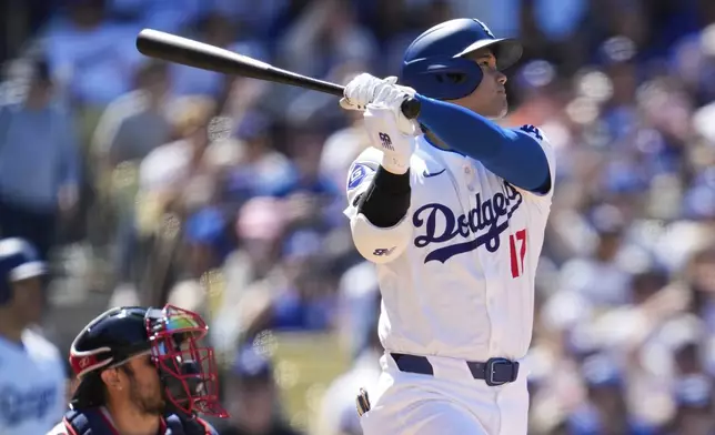 Los Angeles Dodgers designated hitter Shohei Ohtani (17) hits a home run during the eighth inning of a baseball game against the Atlanta Braves in Los Angeles, Sunday, May 5, 2024. (AP Photo/Ashley Landis)