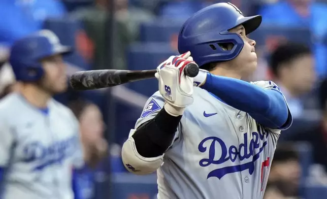 Los Angeles Dodgers' Shohei Ohtani, of Japan, follows through on a two-run home run during the eighth inning of a baseball game against the New York Mets, Wednesday, May 29, 2024, in New York. (AP Photo/Frank Franklin II)