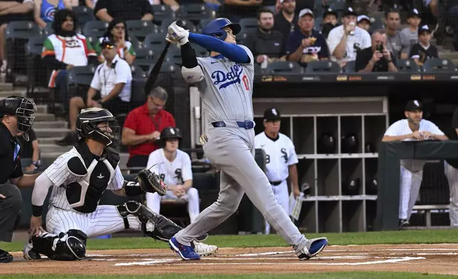 Los Angeles Dodgers designated hitter Shohei Ohtani watches his home run against the Chicago White Sox during the first inning of a baseball game aWednesday, June 26, 2024, in Chicago. (AP Photo/Matt Marton)