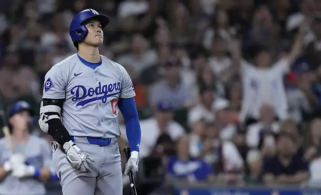 Los Angeles Dodgers designated hitter Shohei Ohtani watches his solo home run leave the park during the third inning of a baseball game against the Houston Astros, Saturday, July 27, 2024, in Houston. (AP Photo/Kevin M. Cox)