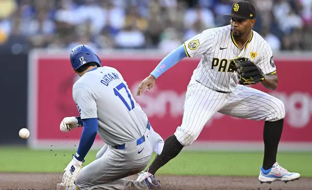 Los Angeles Dodgers designated hitter Shohei Ohtani (17) steals second base ahead of the throw to San Diego Padres second baseman Xander Bogaerts (2) during the first inning of a baseball game Tuesday, July 30, 2024, in San Diego. (AP Photo/Denis Poroy)