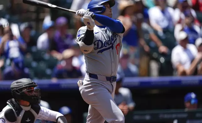 Los Angeles Dodgers' Shohei Ohtani hits a solo home run off Colorado Rockies starting pitcher Ty Blach in the first inning of baseball game Thursday, June 20, 2024, in Denver. (AP Photo/David Zalubowski)