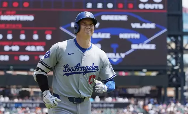 Los Angeles Dodgers designated hitter Shohei Ohtani heads to the dugout after a solo home run during the fifth inning of a baseball game against the Detroit Tigers, Saturday, July 13, 2024, in Detroit. (AP Photo/Carlos Osorio)