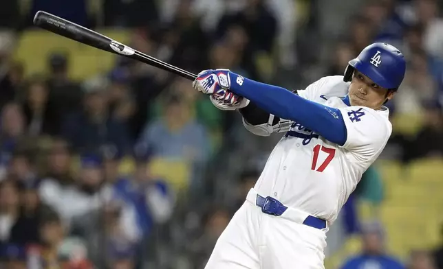 Los Angeles Dodgers' Shohei Ohtani hits a solo home run during the first inning of a baseball game against the San Diego Padres Friday, April 12, 2024, in Los Angeles. (AP Photo/Mark J. Terrill)