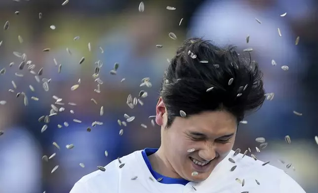 Los Angeles Dodgers designated hitter Shohei Ohtani celebrates his solo-home run during the first inning of a baseball game against the Texas Rangers, Wednesday, June 12, 2024, in Los Angeles. (AP Photo/Ryan Sun)