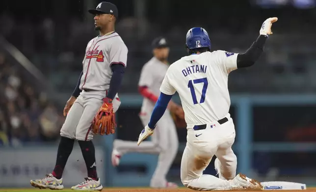 Los Angeles Dodgers designated hitter Shohei Ohtani (17) steals second during the eighth inning of a baseball game against the Atlanta Braves in Los Angeles, Friday, May 3, 2024. (AP Photo/Ashley Landis)