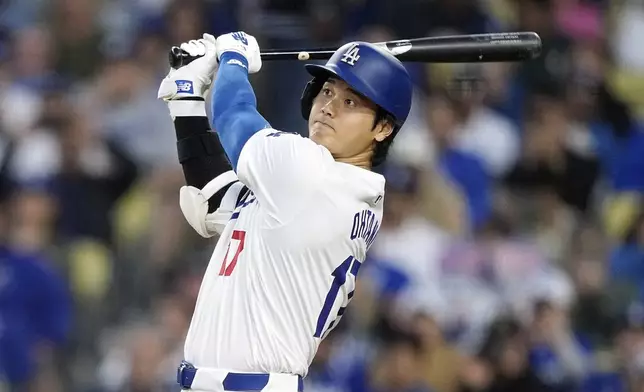 Los Angeles Dodgers designated hitter Shohei Ohtani hits a two-run home run during the third inning of a baseball game against the Cincinnati Reds Friday, May 17, 2024, in Los Angeles. (AP Photo/Mark J. Terrill)