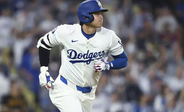 Los Angeles Dodgers' Shohei Ohtani (17) runs to first after hitting a home run against the Pittsburgh Pirates during the second inning of a baseball game at Dodger Stadium Friday, Aug. 9, 2024, in Los Angeles. (AP Photo/John McCoy)