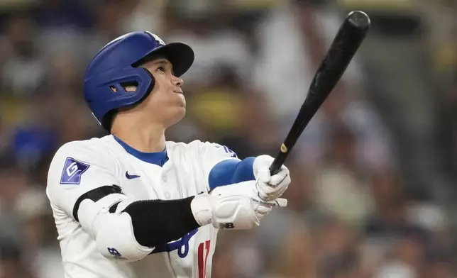 Los Angeles Dodgers designated hitter Shohei Ohtani (17) hits a home run during the sixth inning of a baseball game against the Cleveland Guardians in Los Angeles, Friday, Sept. 6, 2024. (AP Photo/Ashley Landis)