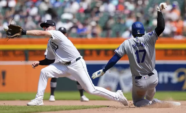 Los Angeles Dodgers designated hitter Shohei Ohtani safely beats the throw to Detroit Tigers second baseman Colt Keith to steal second during the eighth inning of a baseball game, Saturday, July 13, 2024, in Detroit. (AP Photo/Carlos Osorio)