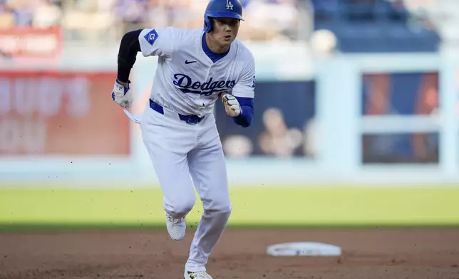 Los Angeles Dodgers designated hitter Shohei Ohtani steals third during the first inning of a baseball game against the Arizona Diamondbacks, Thursday, July 4, 2024, in Los Angeles. (AP Photo/Ryan Sun)