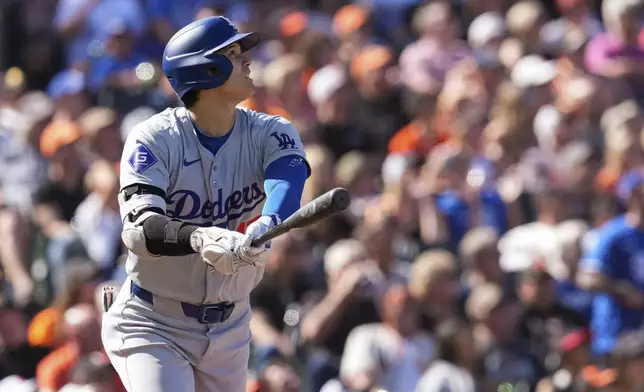 Los Angeles Dodgers' Shohei Ohtani watches his solo home run against the San Francisco Giants during the third inning of a baseball game Saturday, June 29, 2024, in San Francisco. (AP Photo/Godofredo A. Vásquez)