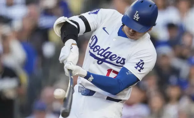 Los Angeles Dodgers designated hitter Shohei Ohtani (17) hits a home run during the third inning of a baseball game against the Atlanta Braves in Los Angeles, Saturday, May 4, 2024. (AP Photo/Ashley Landis)