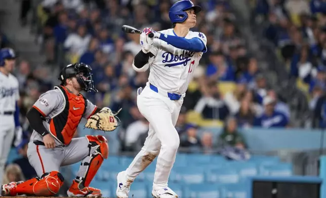 Los Angeles Dodgers designated hitter Shohei Ohtani hits a home run during the seventh inning of a baseball game against the San Francisco Giants in Los Angeles, Wednesday, April 3, 2024. (AP Photo/Ashley Landis)