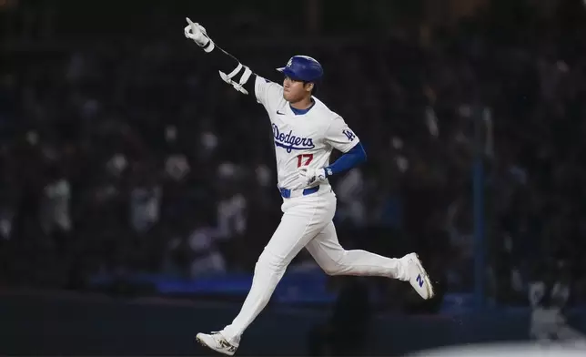 Los Angeles Dodgers designated hitter Shohei Ohtani (17) runs the bases after hitting a home run during the first inning of a baseball game against the Chicago Cubs in Los Angeles, Wednesday, Sept. 11, 2024. (AP Photo/Ashley Landis)