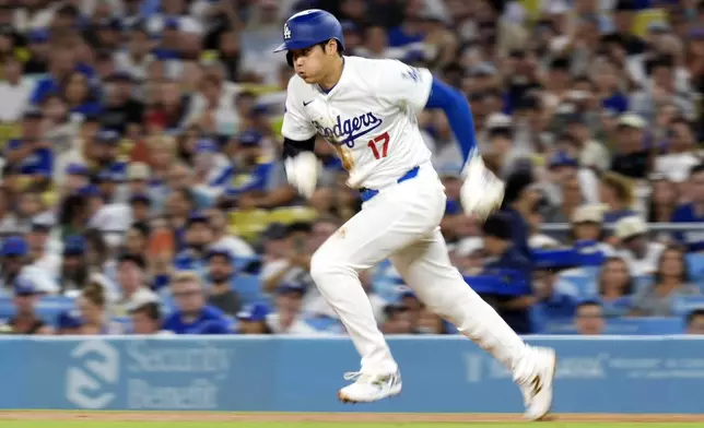 Los Angeles Dodgers' Shohei Ohtani runs from first as he steals second during the third inning of a baseball game against the Chicago Cubs, Monday, Sept. 9, 2024, in Los Angeles. (AP Photo/Mark J. Terrill)