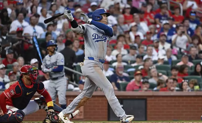 Los Angeles Dodgers' Shohei Ohtani follows through on a home run against the St. Louis Cardinals during the fifth inning of a baseball game Saturday, Aug. 17, 2024, in St. Louis. (AP Photo/Jeff Le)