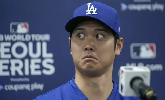 Los Angeles Dodgers' Shohei Ohtani reacts during a news conference ahead of a baseball workout at the Gocheok Sky Dome in Seoul, South Korea, Saturday, March 16, 2024. (AP Photo/Lee Jin-man)